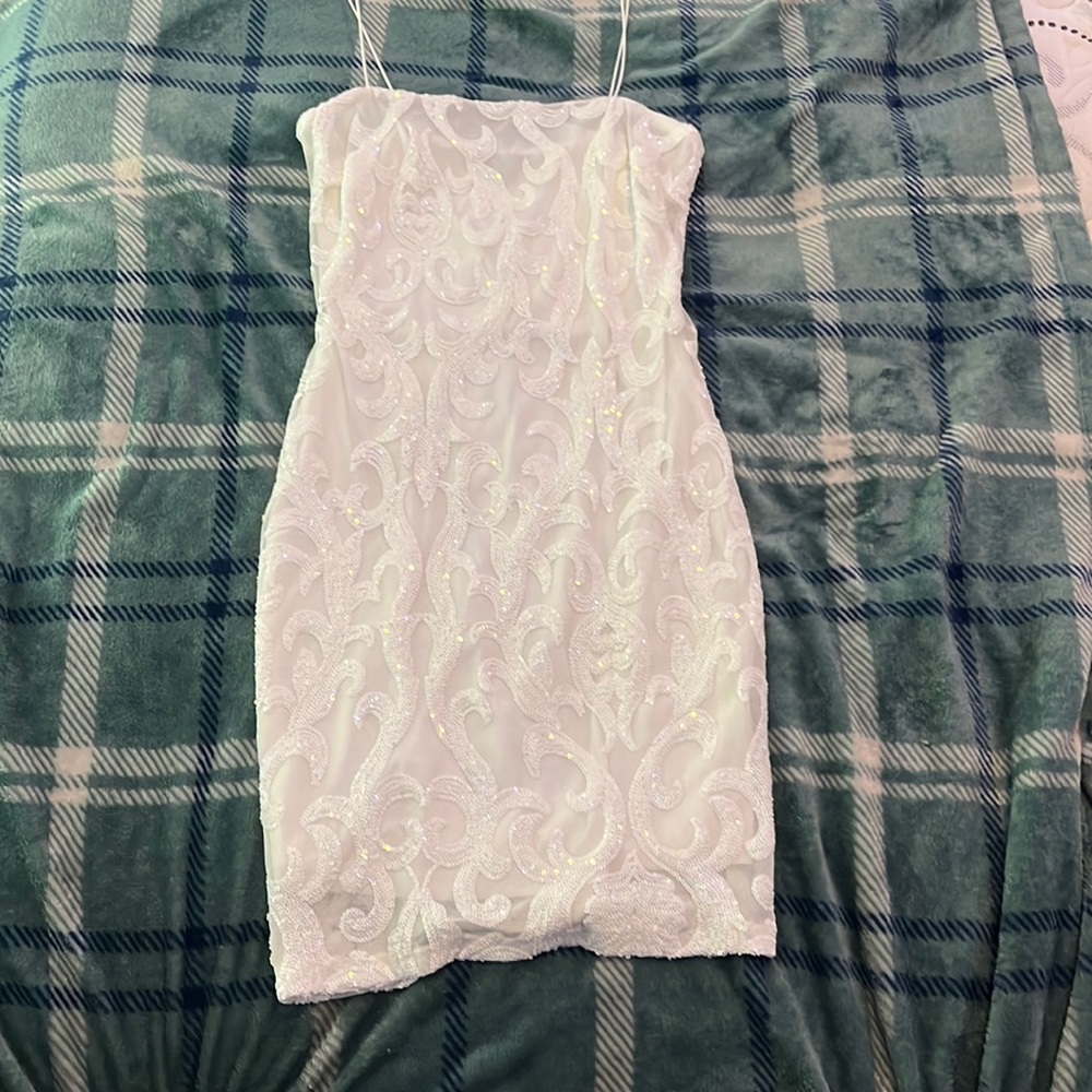 A white sequence dress, spaghetti straps.